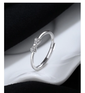 Macro shot of silver bow ring with shimmering pave-set crystals and adjustable band