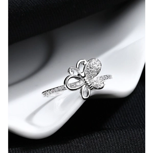 Detailed macro view of S925 silver bow ring featuring pavé set sparkling zircon stones