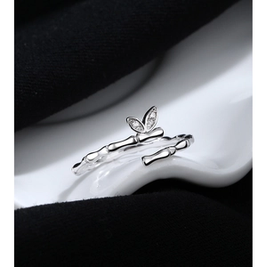 Macro view of adjustable silver bamboo-style ring with leaf-shaped zirconia accents