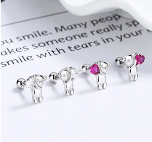 Macro detail of S925 sterling silver koala earrings with heart zircon and screw back