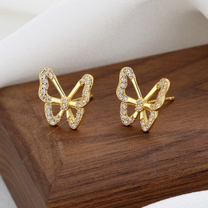 Elegant gold butterfly stud earrings with hollow design and white zircon inlay