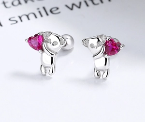 Detailed close-up of S925 silver koala stud earrings holding a pink heart zircon gem