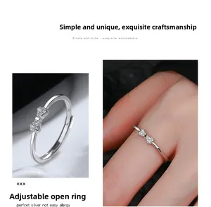 Detail of silver bow ring with crystals featuring an adjustable open band design