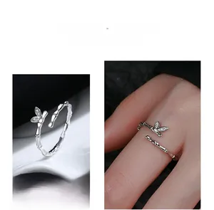 Detail of adjustable silver bamboo joint ring with sparkling diamond leaf accents