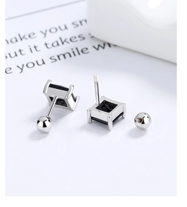 Macro shot of 925 sterling silver square black zircon stud earrings with screw-back design