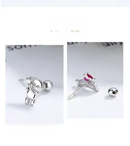 Macro view of S925 silver koala stud earrings featuring heart stones and wing details