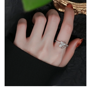 Close-up of 925 sterling silver bow ring with sparkling zircon stones on woman finger