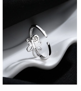 Detailed macro view of 925 silver bow ring with sparkling zircon stones and open band