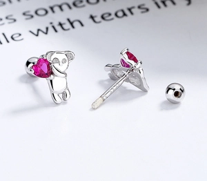 Detailed macro view of S925 sterling silver koala earrings with pink heart and screw backs
