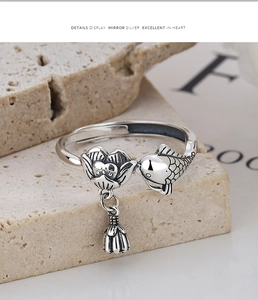 Macro shot of 925 silver koi and lotus ring with a hanging pod charm and vintage finish