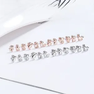 Detailed view of 925 sterling silver animal ear studs in silver and rose gold finishes