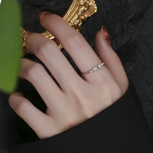 Minimalist 925 sterling silver bow ring with zircon stones on female hand