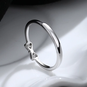 Elegant 925 sterling silver bow ring featuring sparkling zircon accents on white background