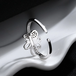 Elegant 925 sterling silver bow open ring with polished metal finish on white stand