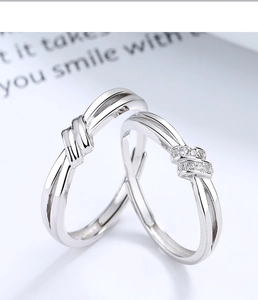 Macro shot of 925 sterling silver lover's knot rings with zircon stones and adjustable band