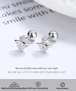 Macro shot of 925 silver planet stud earrings with white zircon and screw back