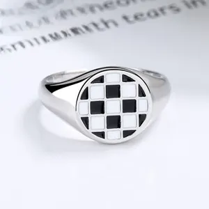 Macro detail of 925 silver koi ring featuring a black and white checkered enamel design