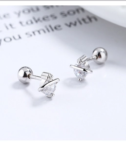 Macro shot of S925 sterling silver planet stud earrings with heart-cut zircon stone