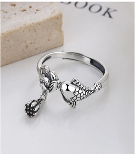 Macro detail of 925 sterling silver lotus and koi fish ring with vintage oxidized finish