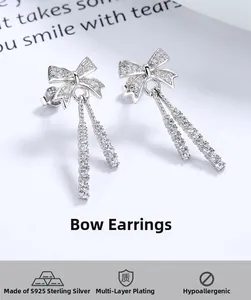 Macro shot of 925 sterling silver bow earrings with sparkling tassel zircon chains