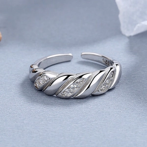 Detailed macro view of S925 sterling silver twist ring with micro-pave zircon inlay