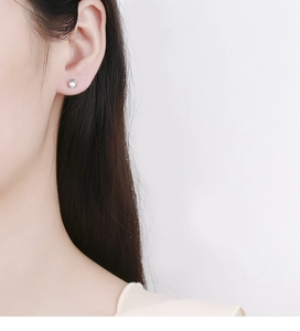 Macro shot of a 925 sterling silver planet stud earring with a sparkling round zircon