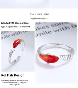 Macro shot of 925 sterling silver koi carp ring with red and orange enamel details