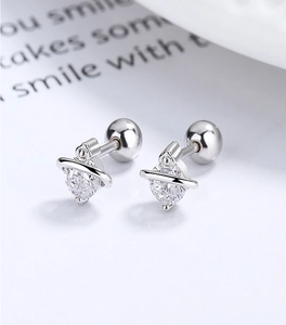 Macro view of 925 sterling silver planet earrings with shiny cubic zirconia and screw back