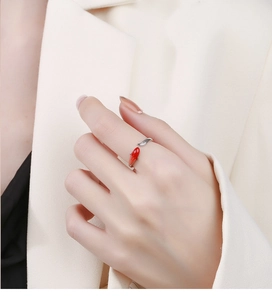 Close-up of a 925 sterling silver koi fish ring with red enamel details on a hand