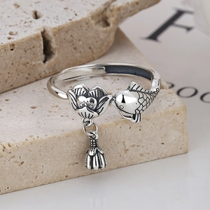 Vintage 925 sterling silver open ring with lotus and koi fish design on travertine base
