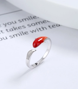 Macro view of koi fish ring with red enamel details on silver adjustable band