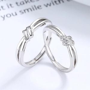 Adjustable 925 sterling silver couple rings with elegant knot design and zircon accents