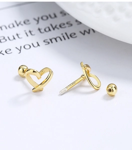 Macro view of gold-plated 925 silver heart stud earrings with secure screw-back closure