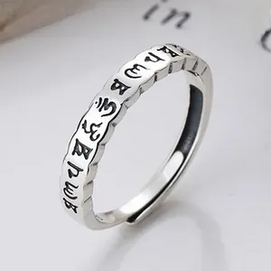 Detailed macro shot of vintage 925 sterling silver ring with engraved sacred characters