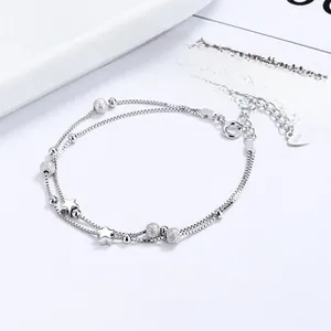 Detail of S925 sterling silver double-layer bracelet with star charm and frosted beads