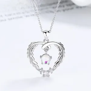 Macro shot of 925 silver heart necklace with iridescent moonstone and tiny diamonds