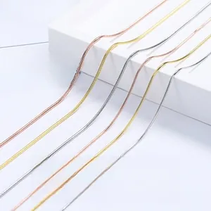 Close-up of 925 sterling silver snake bone bracelets in silver, gold, and rose gold