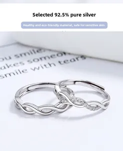 Macro detail of 925 sterling silver infinity rings with polished finish and pavé zircons
