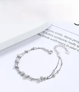 Detail of S925 sterling silver layered bracelet with frosted beads and heart tag