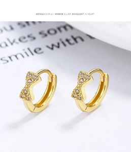Macro shot of 925 sterling silver bow hoop earrings with sparkling zirconia stones
