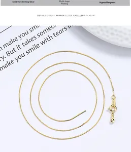 Detailed view of S925 sterling silver box chain with gold plating and needle clasp