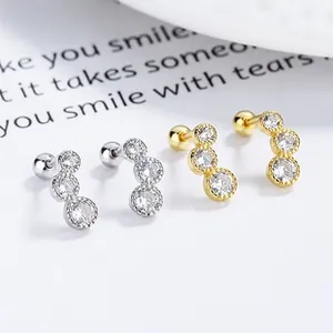 Macro detail of 925 silver stud earrings with gradient triple cubic zirconia stones
