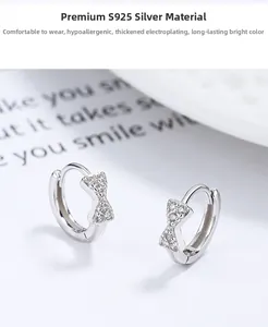 Detailed view of S925 silver bow earrings featuring pavé white cubic zirconia stones