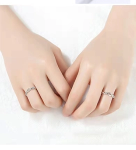 Detail of interlocking 925 silver twist rings on model hands with shimmering zircons