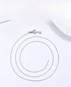 Macro detail of S925 sterling silver box chain necklace with lobster clasp and extension