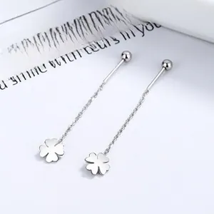 Detail of 925 sterling silver long tassel earrings featuring a four-leaf clover motif