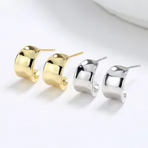 Polished gold and silver C-shape stud earrings in a minimalist metal mirror finish