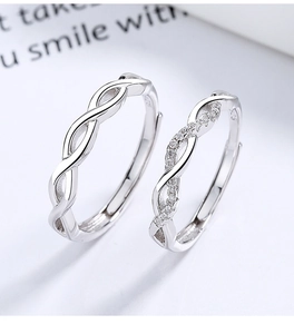 Macro shot of 925 silver moebius couple rings showing polished finish and pavé stones