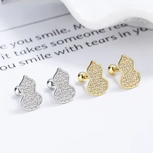 Detailed macro view of 925 sterling silver pave-set diamond gourd earrings in gold and silver