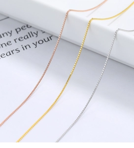 Detailed view of 925 sterling silver box chains in gold, silver, and rose gold finishes